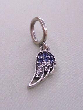 One half of Pandora Sparkling Splittable Angel Wings Dangle Charm